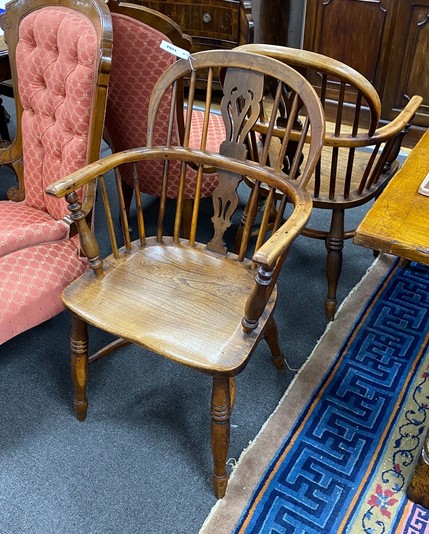 A pair of mid 19th century yew and elm Windsor elbow chairs, with crinoline stretchers, width 55cm, depth 46cm, height 90cm